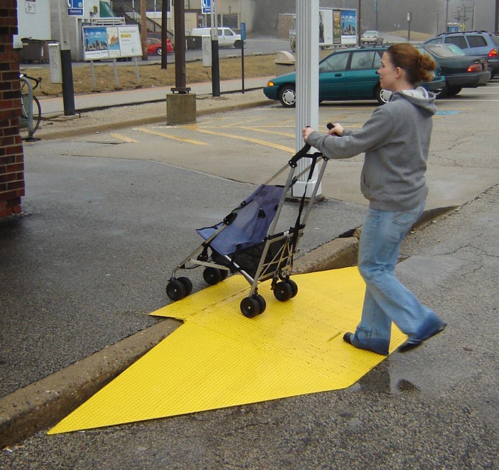 Lady pushing stroller up ramp